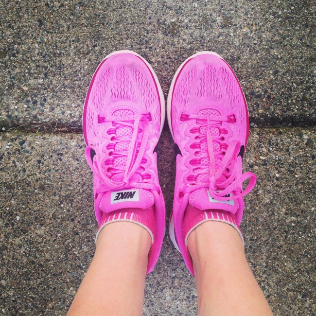 pink running shoes on pavement